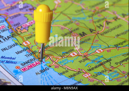 Close view of Pushpin pointing to Mumbai on a map of India Stock Photo