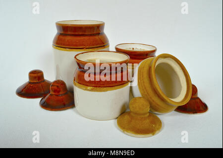 Close view of traditional pickle Jars of ceramic on white background Stock Photo
