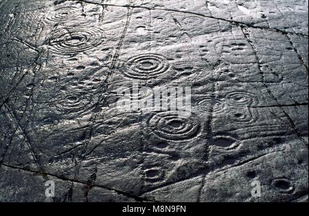 Cup and ring mark marks prehistoric Neolithic rock art on natural rock outcrop at Achnabreck in Kilmartin Valley, Argyll, Scotland, UK