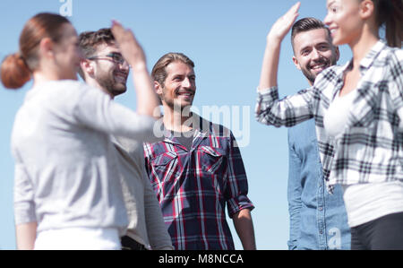friends students giving each other a high five. Stock Photo