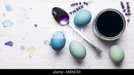 DIY dyed using red cabbage various shades of blue easter eggs drying on piece of polystyrene. DIY Happy Easter theme web banner. Stock Photo
