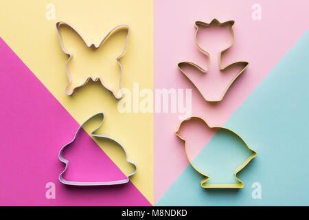 Happy Easter pastel coloured background. Easter themed cookie cutters minimal concept. Stock Photo