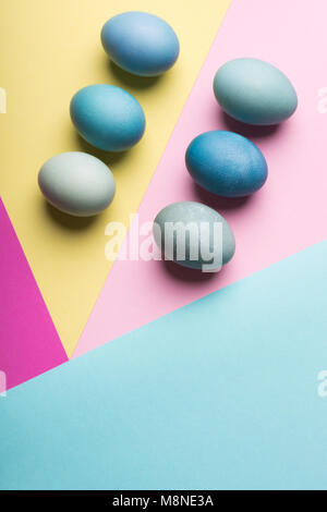Happy Easter pastel coloured background. Hand painted Easter eggs abstract minimal concept. Stock Photo