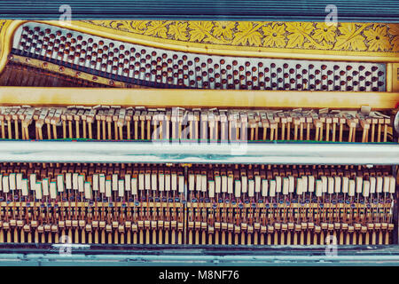 Old piano inside mechanics, colorful hammers and strings background Stock Photo