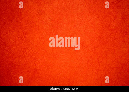 Crumpled paper background, red sheet of wrapping paper. Stock Photo