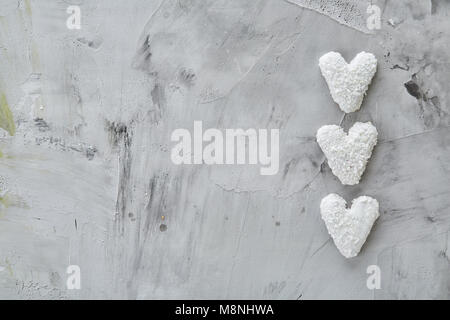 Sweet crunchy coconat heart-shaped biscuits arranged in pattern on light textured background, top view, close-up, shallow depth of field, selective fo Stock Photo