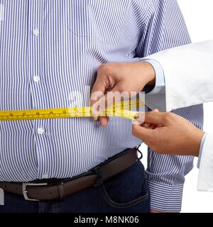 Doctor measuring an overweight man's waist using a tape measure. Stock Photo