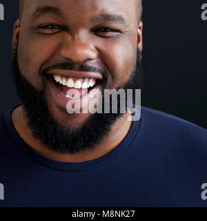 Close up of man laughing and smiling towards camera. Stock Photo