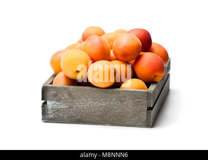 Fresh  apricots on wooden box isolated on white Stock Photo