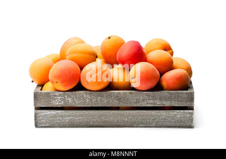 Fresh  apricots on wooden box isolated on white Stock Photo