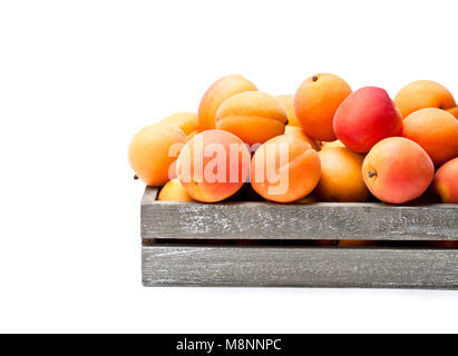 Fresh  apricots on wooden box isolated on white Stock Photo