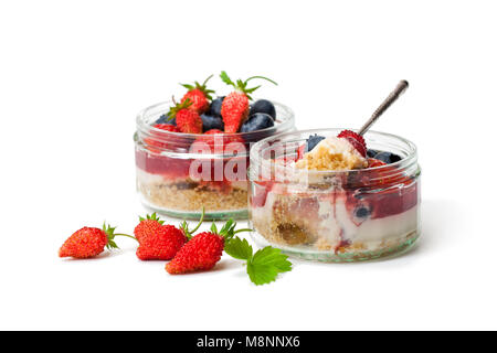 Mini  wild forest berries cheesecake in a glass pots isolated on white background Stock Photo