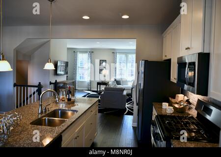 View of kitchen and living room in modern home with open floor plan concept Stock Photo