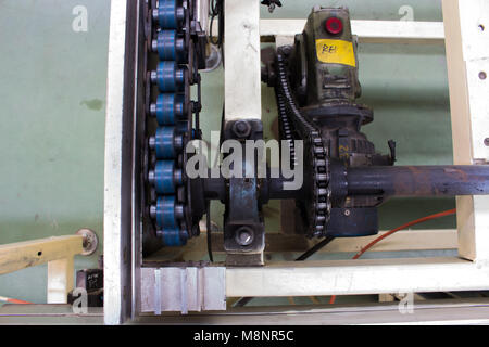 The Conveyor chain drive shaft in factory. Stock Photo