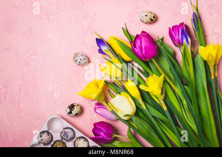 Easter flat lay composition. A bouquet of spring flowers and quail eggs. Stock Photo