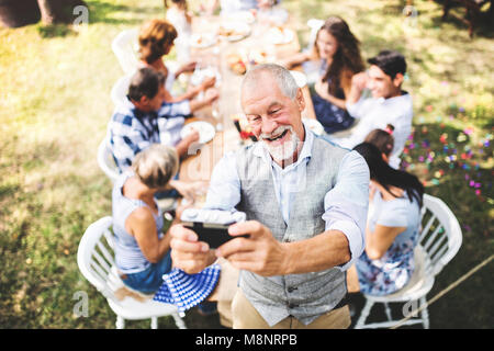 Family celebration or a garden party outside in the backyard. Stock Photo