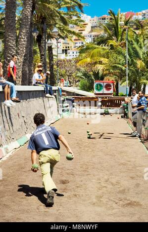 La Gomera, Canary Islands. Bowling alley on the waterfront of San Sebastian. La Gomera playing La Palma. Men playing bolas Stock Photo