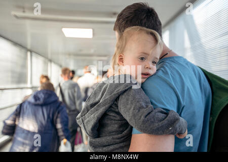 Man with child on travelator Stock Photo