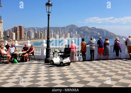 Benidorm, Spain.  March 10, 2018.  Holidaymakers take in the views of Playa de Lavante and relax alfresco on the Point at Benidorm on the Costa Blanca Stock Photo