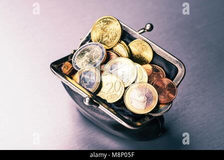Wallet filled with many coins | usage worldwide Stock Photo