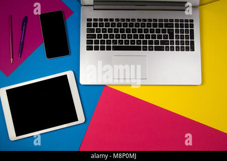 Laptop computer, tablet and mobile phone on colorful background. Stock Photo