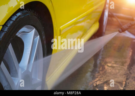 Summer Car Washing. Cleaning Car Using High Pressure Water. Stock Photo