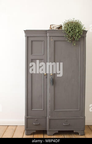 Gray old vintage cupboard in white interior Stock Photo