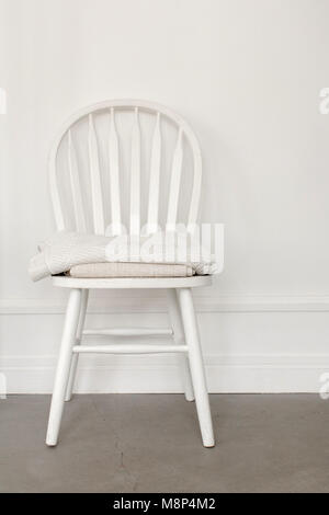White chair on wall background