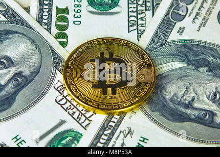 Physical version of Bitcoin new virtual money and banknotes of dollars. Stock Photo