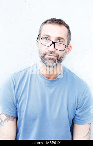 portrait of handsome bearded man with crooked eyeglasses Stock Photo