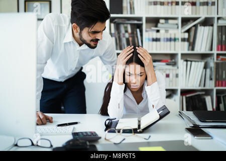 Angry irritated boss reprimanding employee afraid to be fired, accusing of mistake in report, bad work Stock Photo