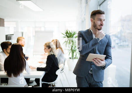 Businessman in modern office using tablet Stock Photo