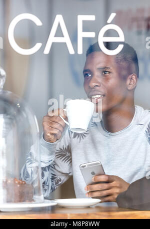 Pretoria, South Africa - Jan 8,2018: African man at a coffee shop. Stock Photo
