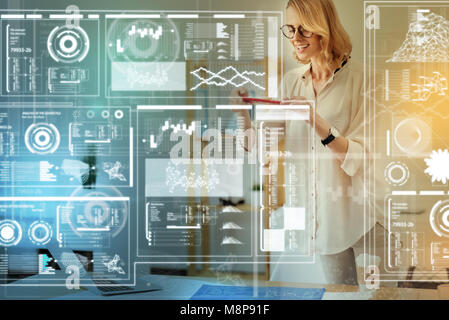 Creative engineer smiling and taking a photo of a blueprint Stock Photo