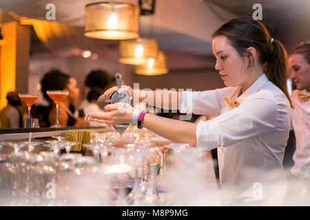 Barlady pouring a cocktail. Stock Photo