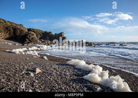 Sea foam created by the agitation of seawater on the beach of Cayola (Les Sables d'Olonne, France) Stock Photo