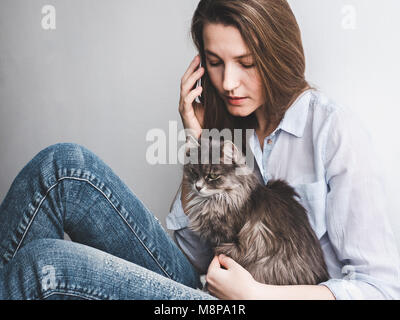 Young woman gently holding a kitten Stock Photo