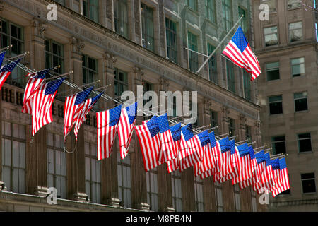 Stars and Stripes flying outside Saks, Fifth Avenue, NYC Stock Photo