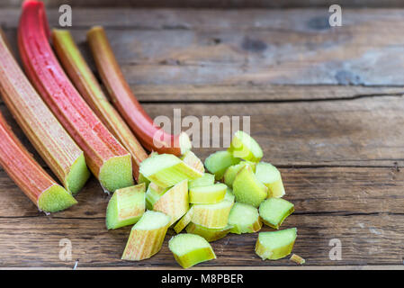 Pieces of Raw and Fresh Cut Rhubarb on Dark Rustic Background Stock Photo