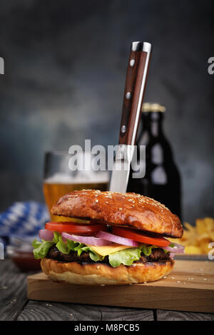 Freshly cooked hamburger with vegetables and cutlet. Home-made sandwich closeup Stock Photo