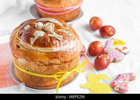 Easter background. Traditional food on the holiday table - Easter Cake, cookies  and Easter painted eggs Stock Photo