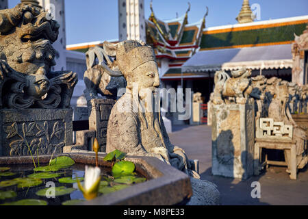 Stone statue of monk in Buddhist Temple Wat Arun in Bangkok, Thailand Stock Photo