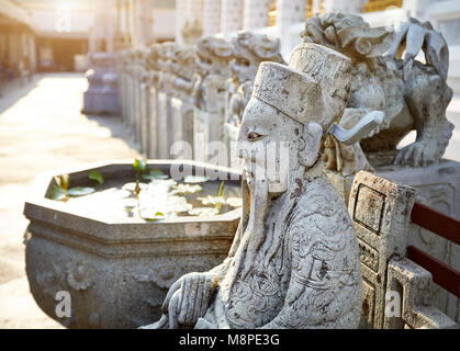 Stone statue of monk in Buddhist Temple Wat Arun in Bangkok, Thailand Stock Photo