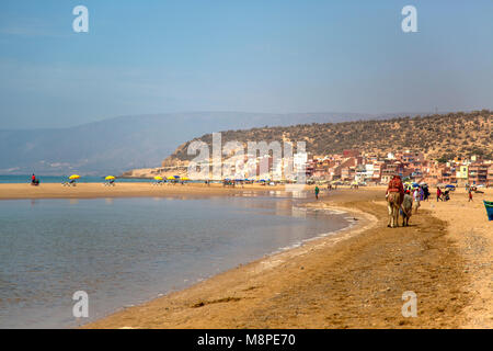 AGADIR, MOROCCO - SEPTEMBER 6, 2014: Unindentified people at beach in Agadir, Morocco. Beaches on Atlantic coast near Agadir are popular tourist desti Stock Photo