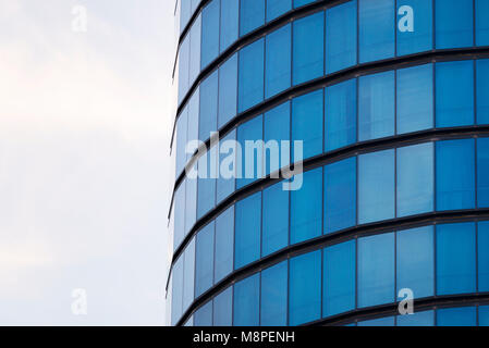 Blue windows of a cylindrical building background texture. Stock Photo