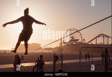 Tight rope practice on beach near the Santa Monica Pier, Los Angeles, CA Stock Photo