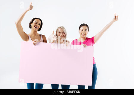 Positive happy women showing thumbs up gestures Stock Photo