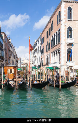 The gondola station at Santa Maria di Giglio and the Grimani Palace Hotel, Grand Canal, Venice,  Veneto, Italy on a sunny blue sky day Stock Photo