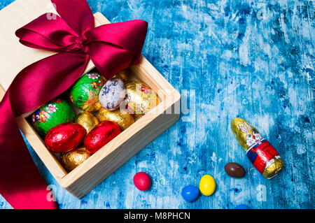 Chocolate eggs candies in a box with red ribbon Stock Photo