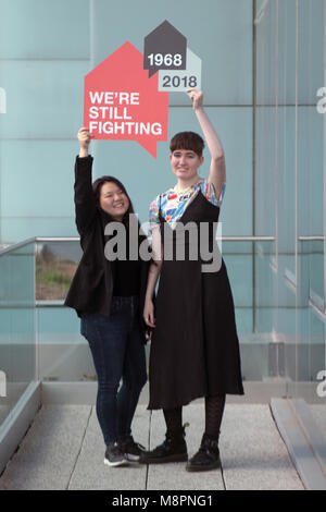 Glasgow, Scotland, UK. 19th March, 2018. Two students studying Communication Design at the Glasgow School of Art (the GSA) have won a competition to design a logo for housing and homelessness charity, Shelter Scotland's 50th anniversary. The young designers, Emily Wang (aged 21, from Hong Kong) and Sophie Rowan (aged 21, from Motherwell), submitted concepts for the contest, judged by the GSA and Shelter Scotland. Pictured are Emily (left) and Sophie (right). Iain McGuinness / Alamy Live News Stock Photo